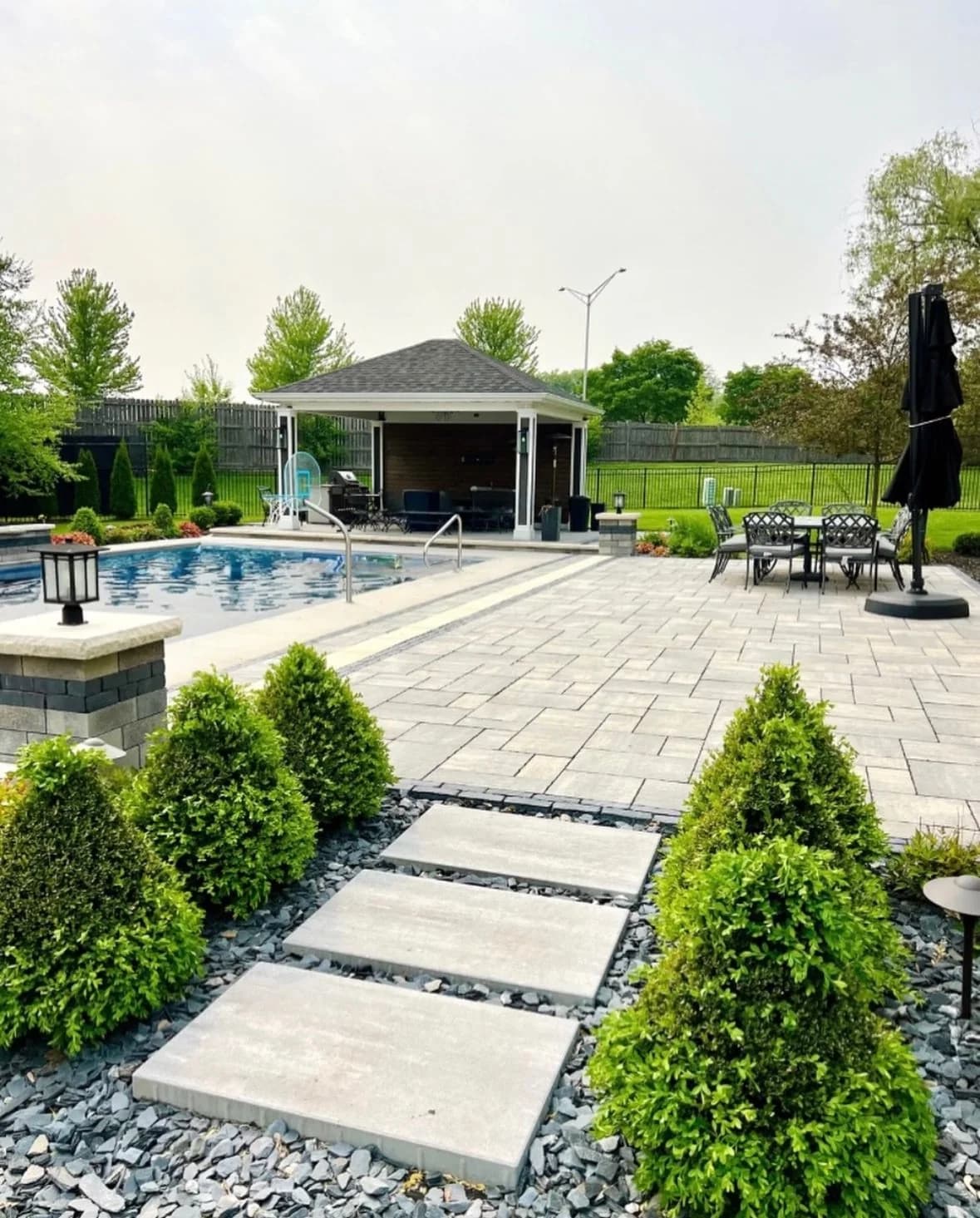 Broad paved garden path with contrasting borders and planted beds